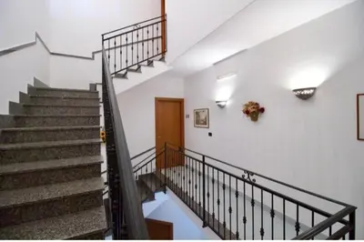 a staircase in a building with a stair case at Salina in Trappeto