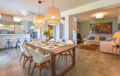 a dining room and living room with a table and chairs at Gorgeous Home In Balestrate With Wifi in Balestrate