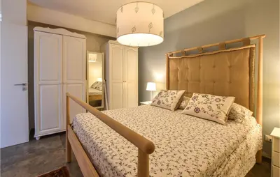 a bedroom with a large bed with a wooden headboard at Gorgeous Home In Balestrate With Wifi in Balestrate