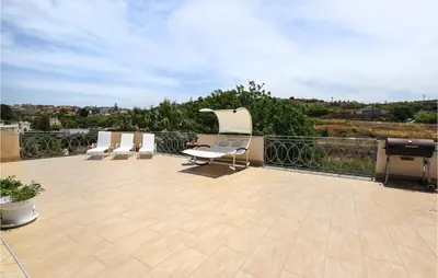 a patio with chairs and a grill on a roof at Pet Friendly Home In Balestrate in Balestrate