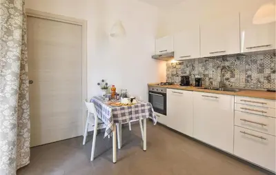 a kitchen with a table with a table cloth at Pet Friendly Home In Balestrate in Balestrate