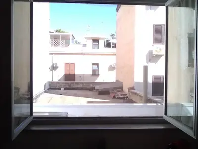 an open window with a view of a building at Na' zà Ciccina in Palermo