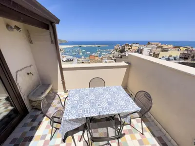 a table and chairs on a balcony with a view at Sicilia Ovest - Sea View Terrace Sofia in Castellammare del Golfo