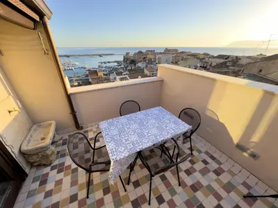a table and chairs on a balcony with a view at Sicilia Ovest - Sea View Terrace Antiche Scale in Castellammare del Golfo