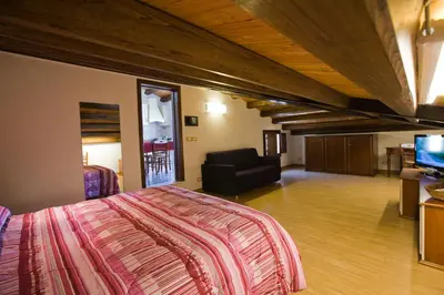 a bedroom with a bed and a couch and a television at Sicilia Ovest - Sea View Terrace Antiche Scale in Castellammare del Golfo