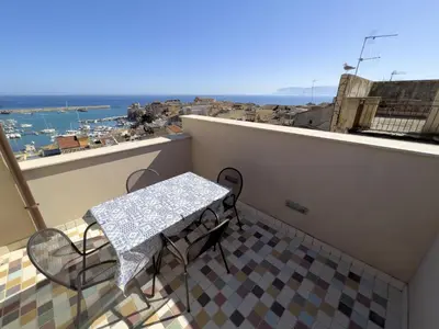 a table and chairs on a balcony with a view at Sicilia Ovest - Sea View Terrace Antiche Scale in Castellammare del Golfo