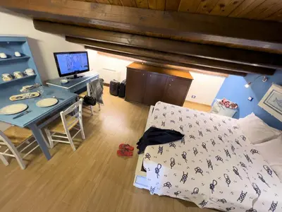 a bedroom with a bed and a desk with a computer at Sicilia Ovest - Sea View Balcony Cerri in Castellammare del Golfo