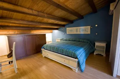 a bedroom with a bed and a wooden ceiling at Sicilia Ovest - Sea View Balcony Cerri in Castellammare del Golfo