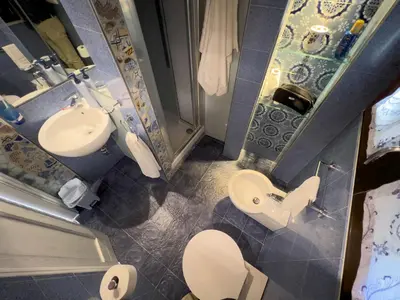 a small bathroom with a toilet and a sink at Sicilia Ovest - Sea View Balcony Cerri in Castellammare del Golfo