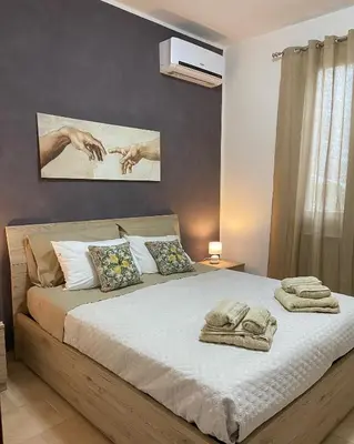 a bedroom with a bed with towels on it at L'Oasi dell'Eremita in Mondello