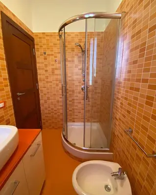 a bathroom with a shower and a sink and a toilet at L'Oasi dell'Eremita in Mondello