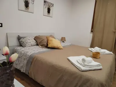 a bedroom with a bed with towels on it at Momaliar House in Campofelice di Roccella