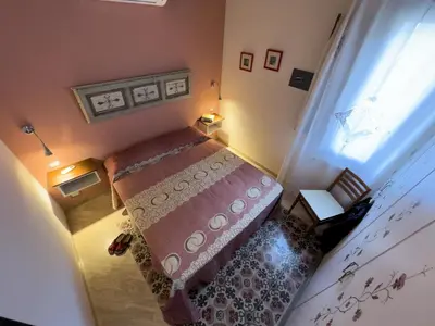 a small bedroom with a bed and a window at Sicilia Ovest - Sea View Terrace Dolce Vita in Castellammare del Golfo