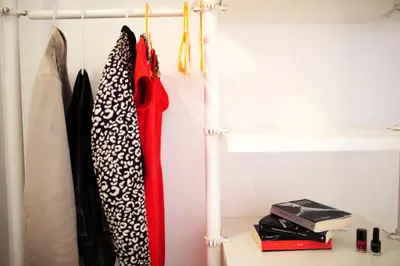 a closet with three ties hanging on a rack at Kòre rooms in Castellammare del Golfo