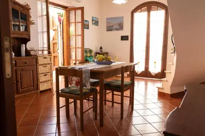 a kitchen with a table with a bowl of fruit on it at La Palma in San Vito lo Capo