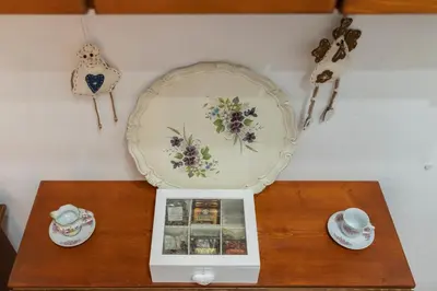 a table with a clock and a plate on a wall at La Palma in San Vito lo Capo