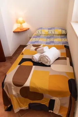 a bedroom with two beds with towels on them at La Palma in San Vito lo Capo