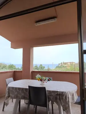 a dining room with a table and chairs and a window at Villa Giardini in Balestrate