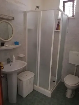 a bathroom with a shower and a sink and a toilet at Villa Giardini in Balestrate