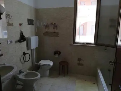a bathroom with a toilet and a sink and a tub at Villa Giardini in Balestrate