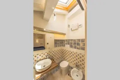a bathroom with two toilets and a sink at Design loft Marinella in Porticello in Santa Flavia