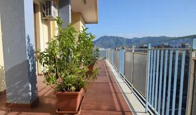 a balcony with potted plants on the side of a building at Villabianca Vacanze in Palermo