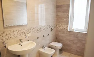 a bathroom with a sink and a toilet and a mirror at Villabianca Vacanze in Palermo