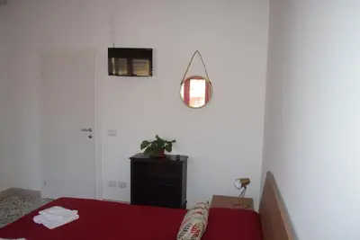 a bedroom with a bed and a potted plant at Villabianca Vacanze in Palermo