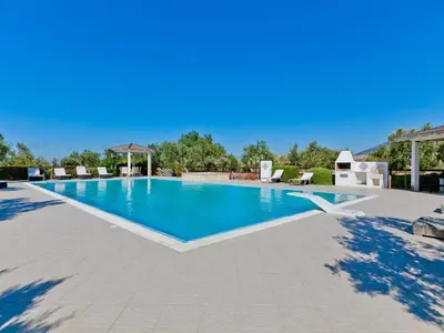 a large swimming pool with blue water in a resort at Villa Tenute Aversa by Interhome in Castellammare del Golfo