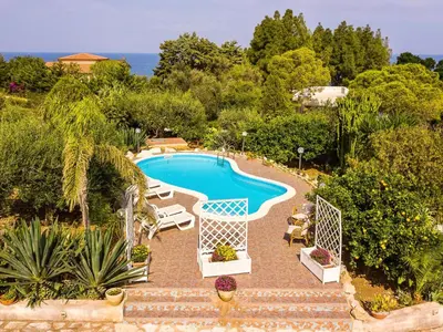 an image of a swimming pool in a garden at Villa La Vela by Interhome in Scopello