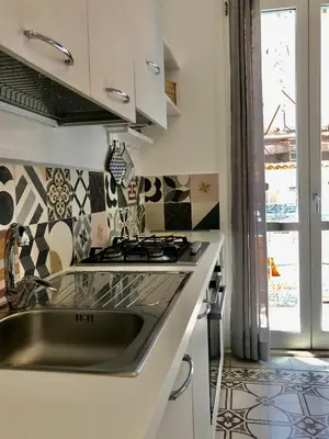 a kitchen with a sink and a stove at Casa Colore Loft in Castellammare del Golfo