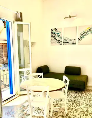 a living room with a table and chairs and a couch at Casa Colore Loft in Castellammare del Golfo