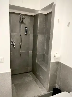 a bathroom with a shower with a glass door at Quattro Canti al Cassaro in Palermo