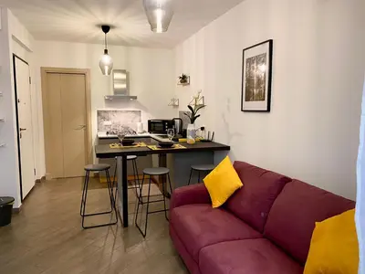 a living room with a purple couch and a table at Quattro Canti al Cassaro in Palermo