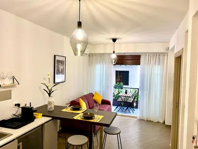 a kitchen and living room with a table and chairs at Quattro Canti al Cassaro in Palermo