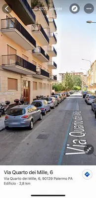 a street with cars parked in a parking lot at B&B Bellavista in Palermo