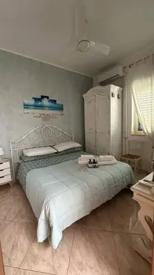 a bedroom with a large bed in a room at mondello lilla' room in Palermo