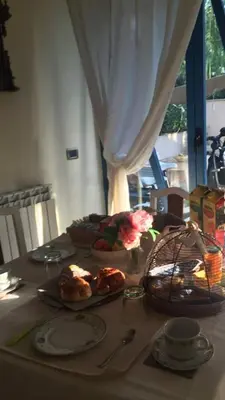 a table with plates of food on top of it at mondello lilla' room in Palermo