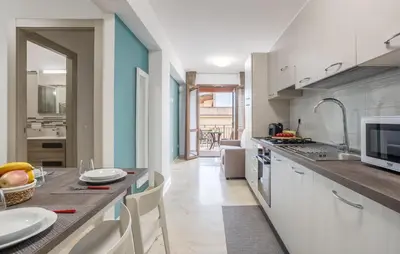 a kitchen with a counter with a table and chairs at Cozy Apartment In Balestrate With Wifi in Balestrate