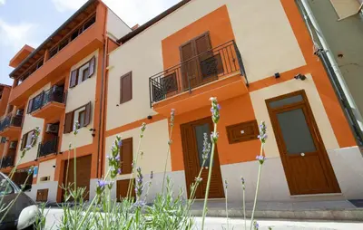a building with orange and white at Cozy Apartment In Balestrate With Wifi in Balestrate