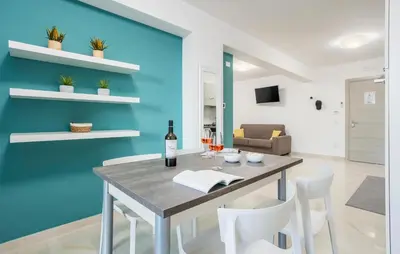 a dining room with blue walls and a table and chairs at Beautiful Apartment In Balestrate in Balestrate