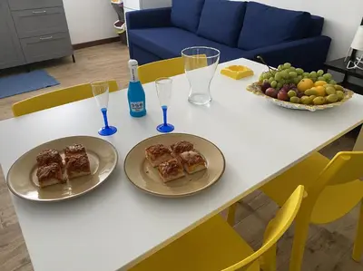 a white table with two plates of food on it at Patio1861 - A Sicilian deluxe apartment in Termini Imerese