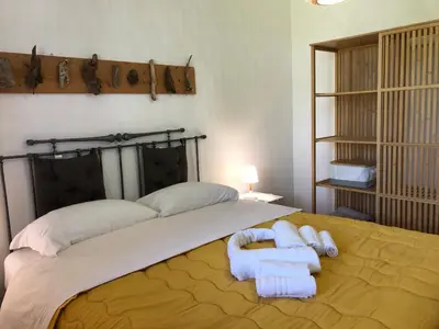 a bedroom with a bed with two towels on it at TORRE MARIZA Guidaloca in Scopello