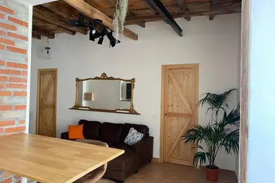 a living room with a couch and a mirror at Casaescape City in Palermo