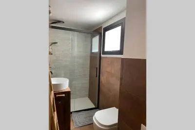 a bathroom with a toilet and a sink at Casaescape City in Palermo