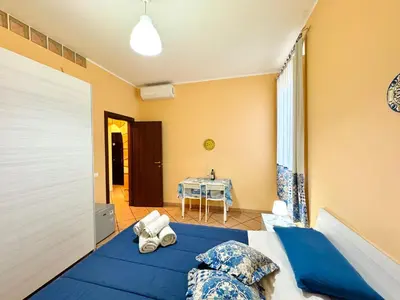 a bedroom with a blue bed and a table at Le Maioliche in Sferracavallo