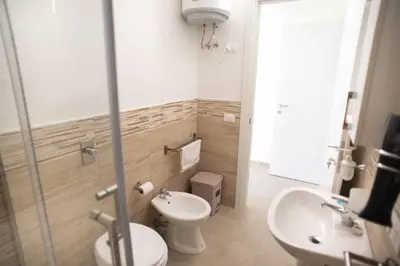 a bathroom with a toilet and a sink at Isola bella in Isola delle Femmine