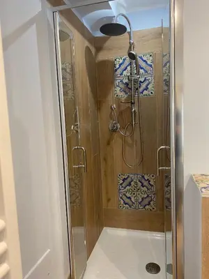 a shower with a glass door in a bathroom at La casetta di Maria alla Ciba in Termini Imerese