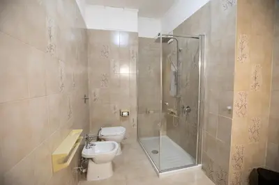 a bathroom with a shower and a toilet and a sink at B&B Azul in Palermo