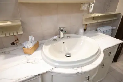 a bathroom with a sink and a white counter top at B&B Azul in Palermo